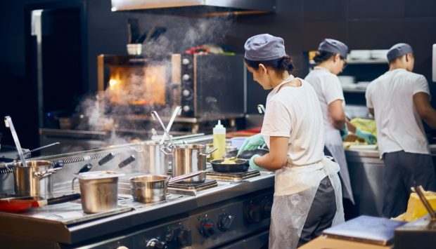 Foodservice equipment cooks in commercial kitchen restaurant